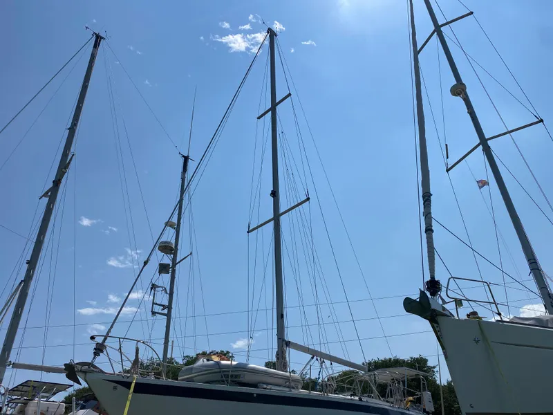 Slide: The Image of 1972 Ericson 39 Flushdeck sailboat with tall masts against a clear blue sky. - 21