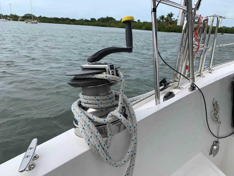 Slide: The Image of Ericson 39 Flushdeck sailboat winch with rope, 1972 model, on calm water. - 23
