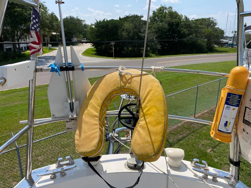 Slide: The Image of 1972 Ericson 39 Flushdeck sailboat with life preserver and safety equipment on deck. - 28