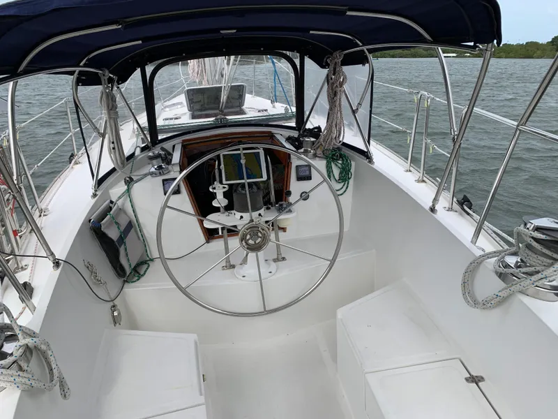 Slide: The Image of 1972 Ericson 39 Flushdeck sailboat cockpit with steering wheel and canopy. - 35