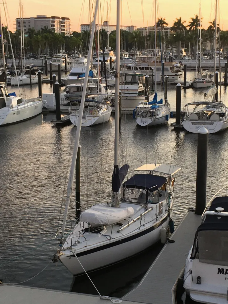 Slide: The Image of 1972 Ericson 39 Flushdeck sailboat docked in a marina at sunset. - 4