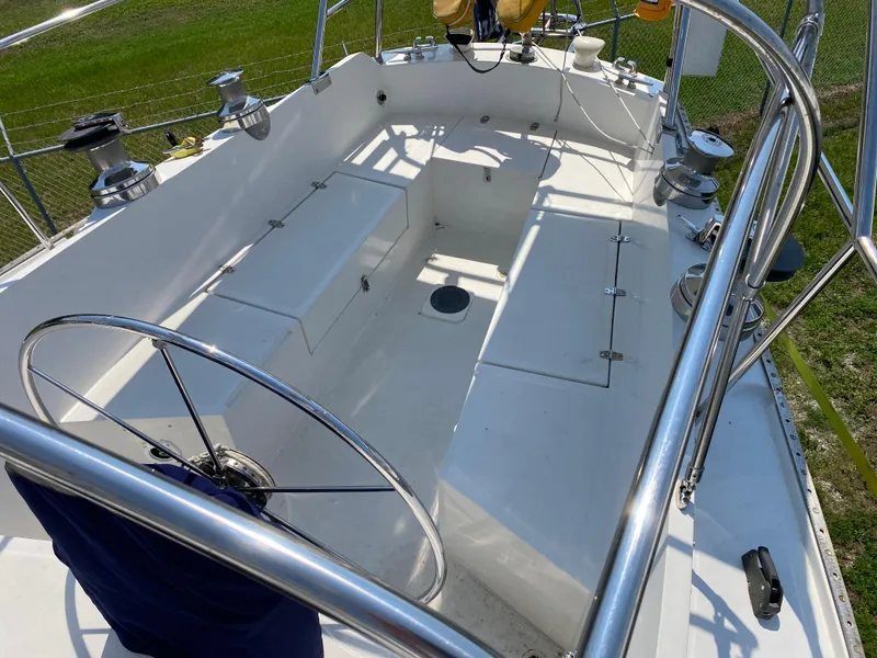 Slide: The Image of 1972 Ericson 39 Flushdeck sailboat cockpit with steering wheel and seating. - 41