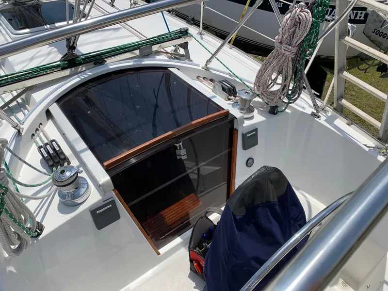 Slide: The Image of 1972 Ericson 39 Flushdeck sailboat cockpit with ropes and winches. - 43