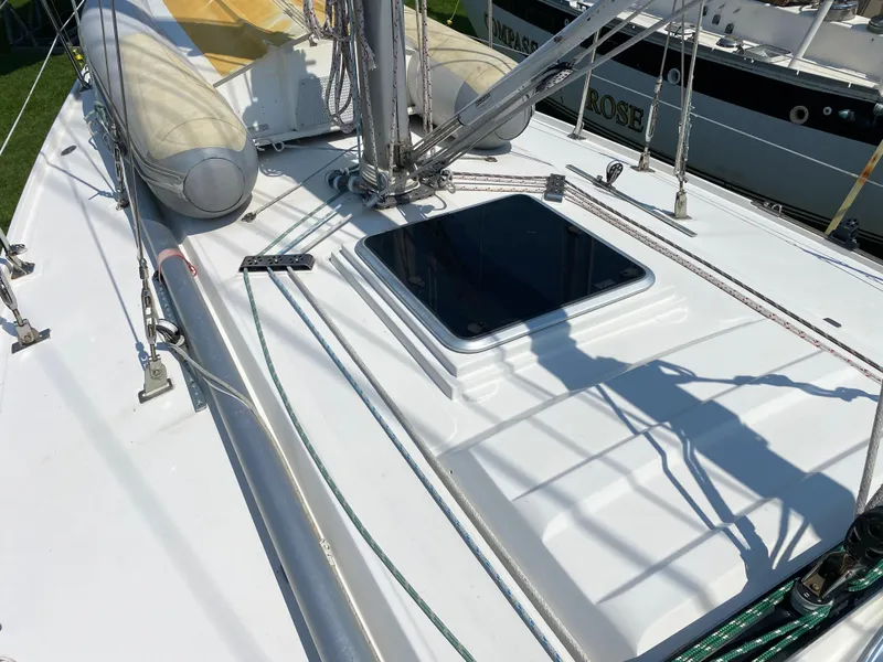 Slide: The Image of 1972 Ericson 39 Flushdeck sailboat deck with hatch and rigging. - 47