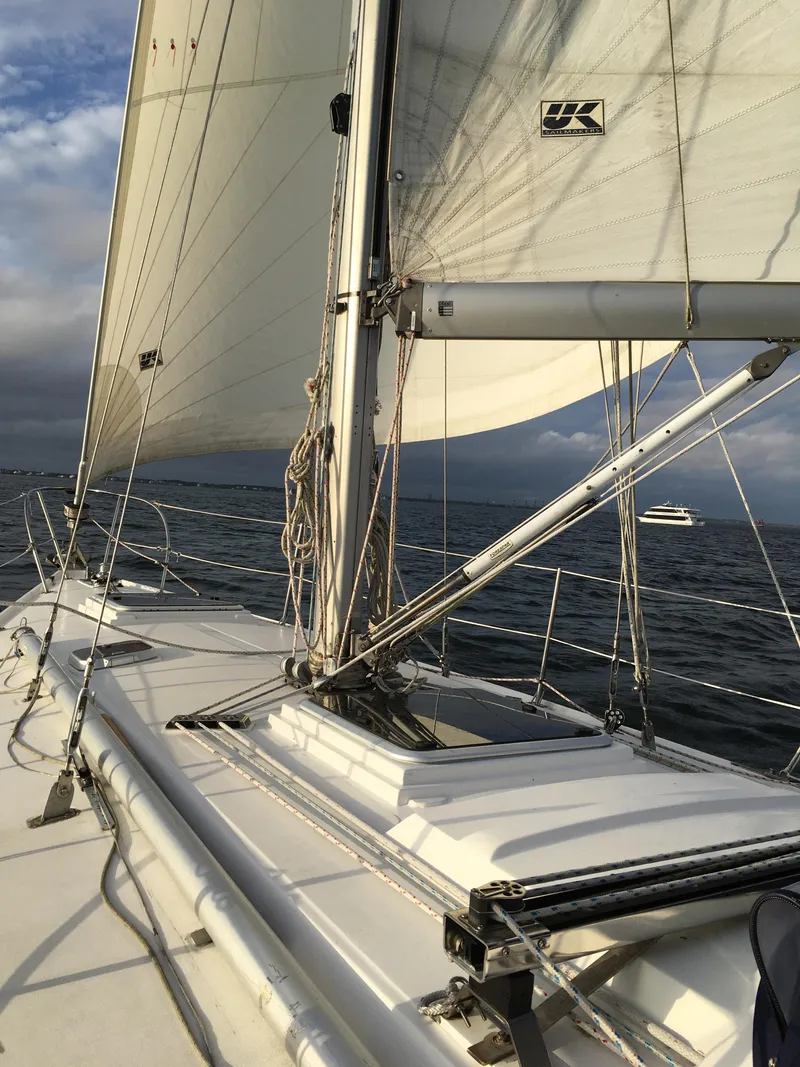 Slide: The Image of 1972 Ericson 39 Flushdeck sailboat on open water, sails fully raised. - 48