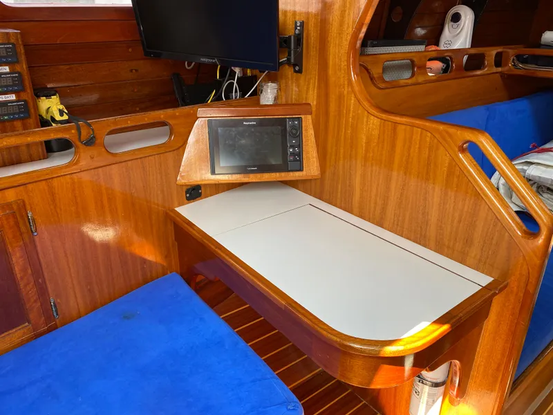 Slide: The Image of Interior of 1972 Ericson 39 Flushdeck sailboat with wooden finish and blue seating. - 60