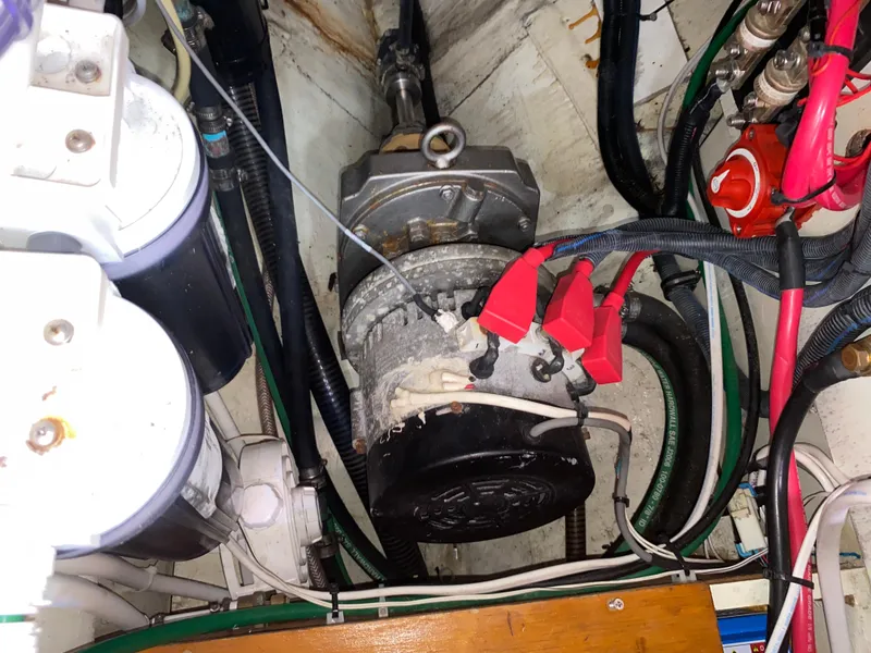 Slide: The Image of Engine compartment of 1972 Ericson 39 Flushdeck sailboat, showing mechanical components and wiring. - 74