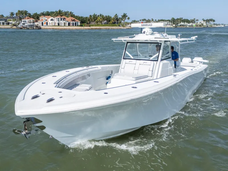 Slide: The Image of 2019 Yellowfin 42 Offshore boat cruising on a sunny day near waterfront homes. - 1