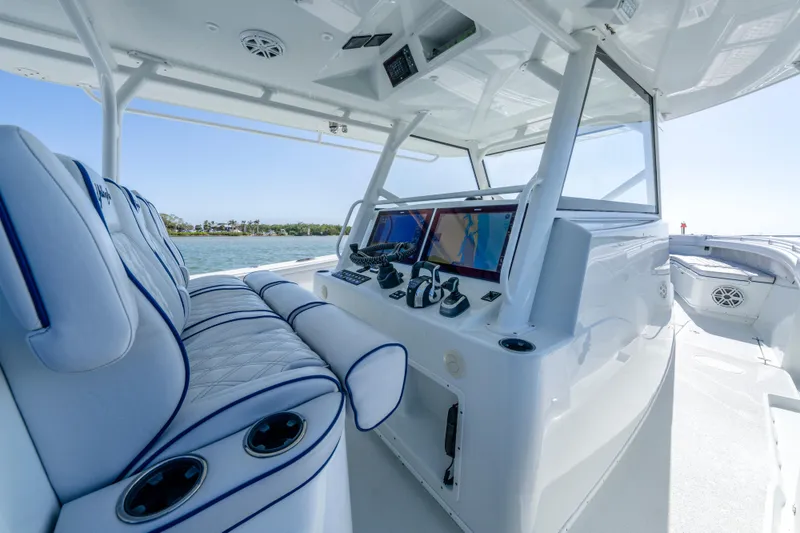 Slide: The Image of 2019 Yellowfin 42 Offshore boat interior with modern navigation system and plush seating. - 17