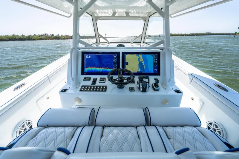 Slide: The Image of 2019 Yellowfin 42 Offshore boat cockpit with navigation screens and controls on open water. - 18