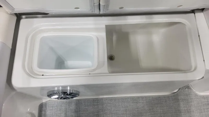 Slide: The Image of 2024 Formula 270 Bowrider storage compartments with drain plug. - 20