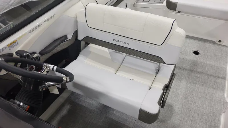 Slide: The Image of 2024 Formula 270 Bowrider interior with white seating and steering wheel. - 24