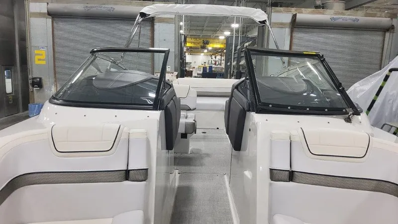 Slide: The Image of 2024 Formula 270 Bowrider interior with dual windshields in a showroom setting. - 27