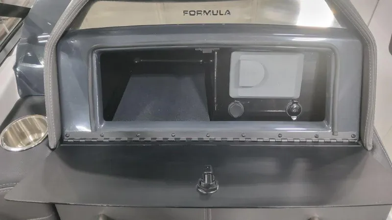 Slide: The Image of 2024 Formula 270 Bowrider dashboard with storage compartment and controls. - 32