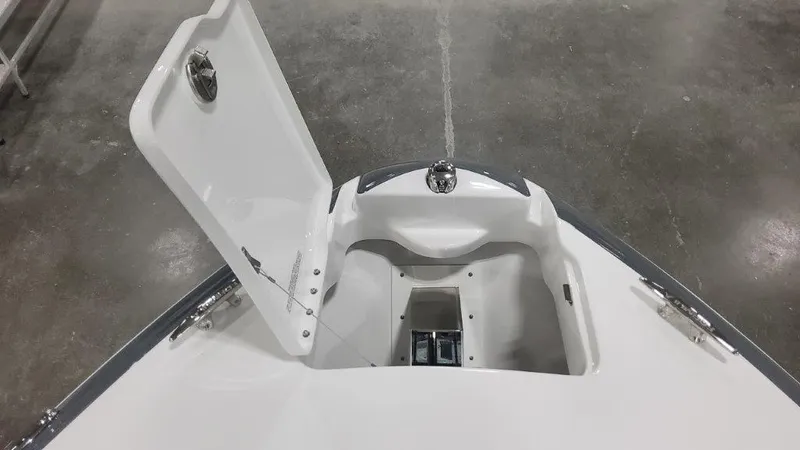 Slide: The Image of 2024 Formula 270 Bowrider open storage compartment on sleek white deck. - 38