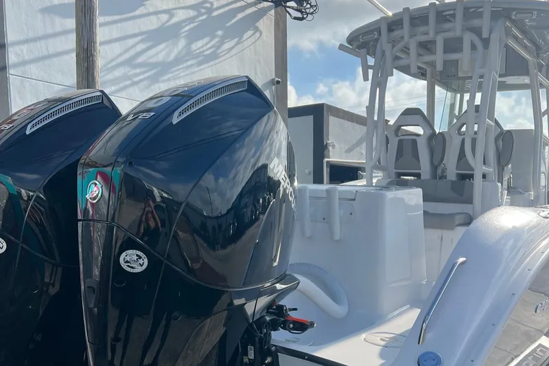 Slide: The Image of 2024 Cape Horn 32xs boat with dual outboard engines, sleek design, and spacious seating. - 12