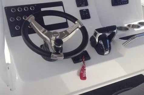 Slide: The Image of 2024 Cape Horn 32xs boat dashboard with steering wheel and controls. - 3