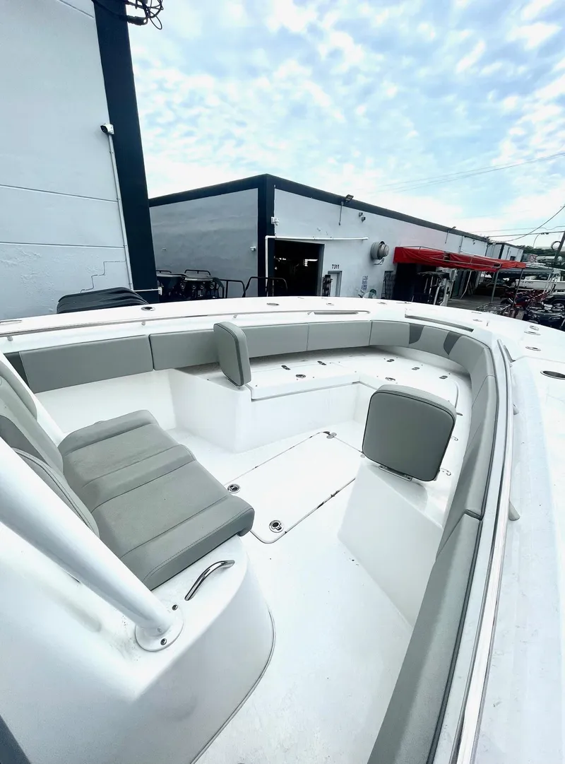 Slide: The Image of 2024 Cape Horn 32xs boat interior with gray seating, docked outdoors. - 7
