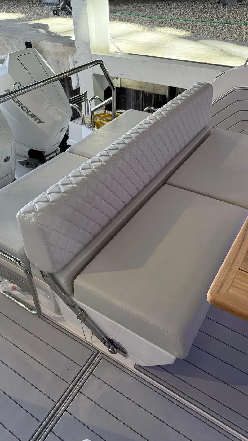 Slide: The Image of Luxurious seating on 2025 Schaefer 375 yacht with quilted upholstery and wooden table. - 11