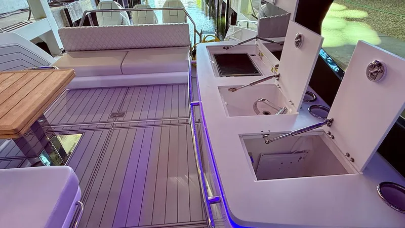 Slide: The Image of Luxurious 2025 Schaefer 375 yacht interior with seating, table, and kitchenette. - 21