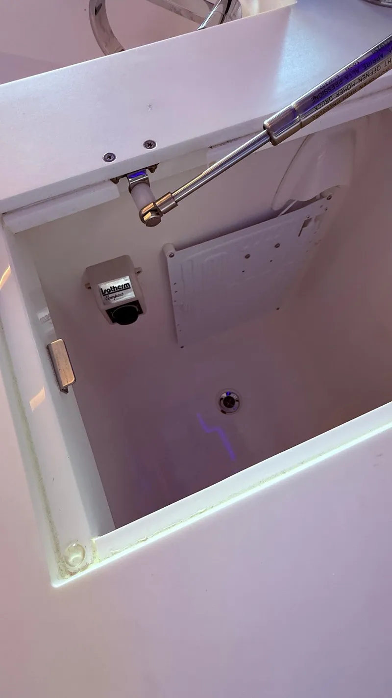 Slide: The Image of Open compartment of Schaefer 375 boat, showcasing interior details and hydraulic support. - 24