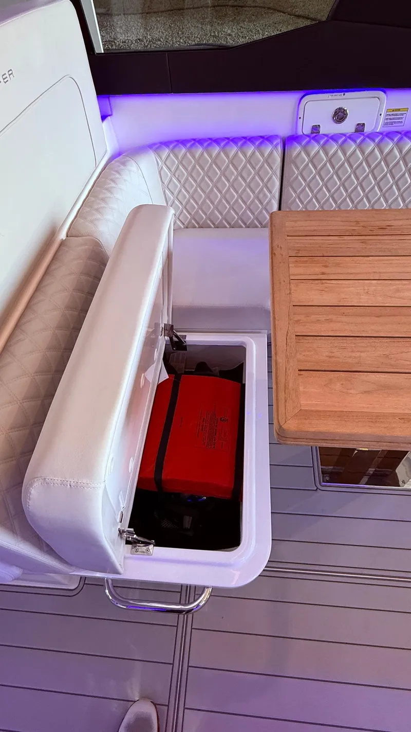 Slide: The Image of Luxury Schaefer 375 yacht interior with storage compartment and wooden table, 2025 model. - 26