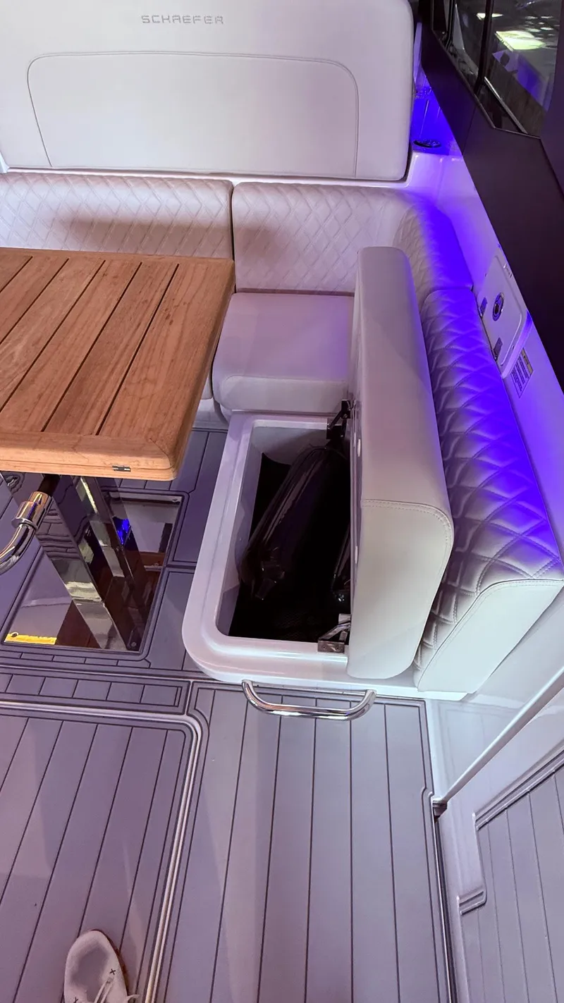 Slide: The Image of Luxury seating area on 2025 Schaefer 375 yacht with storage compartment. - 27