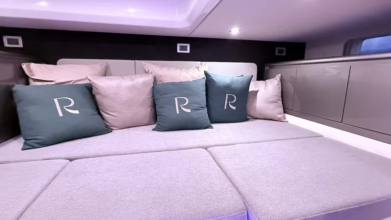 Slide: The Image of Luxurious interior of 2025 Schaefer 375 yacht with plush seating and decorative pillows. - 41