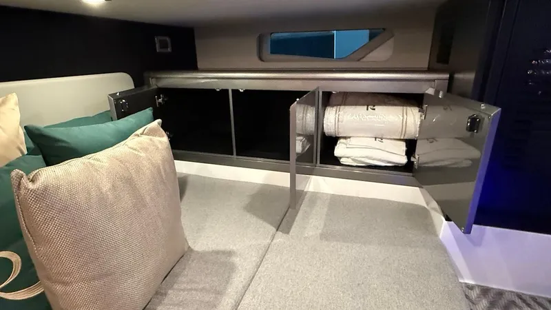 Slide: The Image of Schaefer 375 yacht interior, 2025 model, featuring open storage with bedding and cushions. - 45