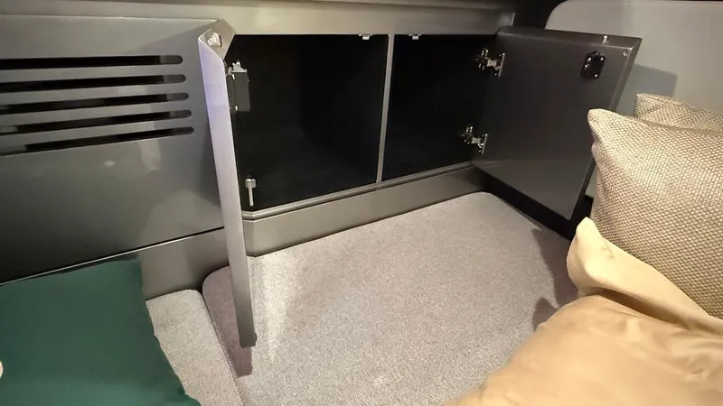 Slide: The Image of Interior of 2025 Schaefer 375 yacht with open storage compartment and cozy bedding. - 46