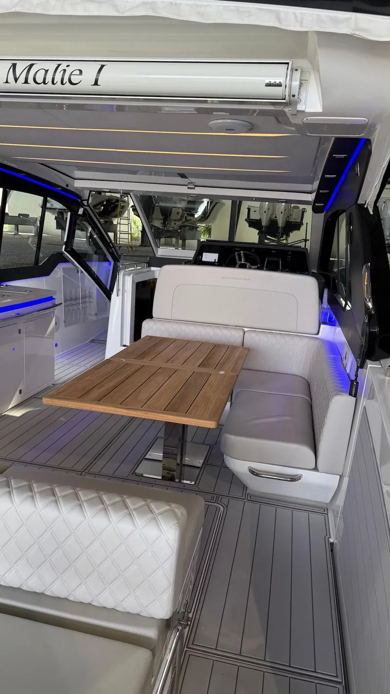 Slide: The Image of Luxurious interior of 2025 Schaefer 375 yacht with elegant seating and wooden table. - 5