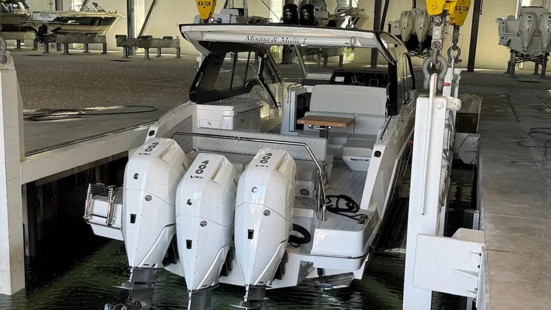 Slide: The Image of Schaefer 375 boat in dock, featuring dual outboard engines, 2025 model. - 7