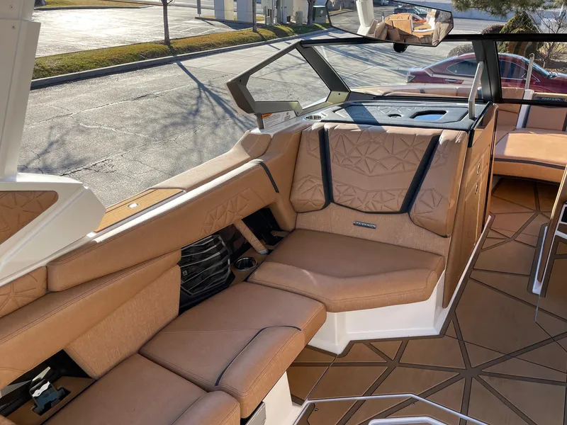 Slide: The Image of 2024 Nautique Super Air Nautique G25 Paragon interior with luxurious tan seating. - 10