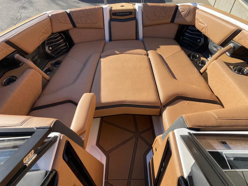 Slide: The Image of 2024 Nautique Super Air Nautique G25 Paragon interior with luxurious tan seating. - 11