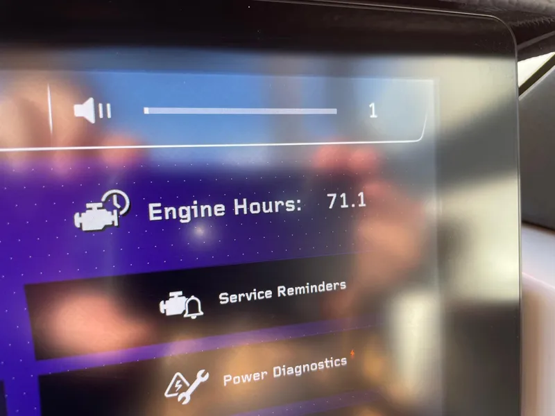 Slide: The Image of Dashboard display showing 71.1 engine hours on 2024 Nautique Super Air Nautique G25 Paragon. - 13