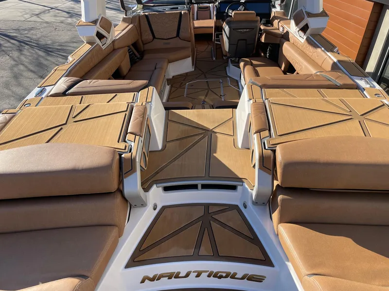 Slide: The Image of 2024 Nautique Super Air Nautique G25 Paragon interior with luxurious tan seating. - 4