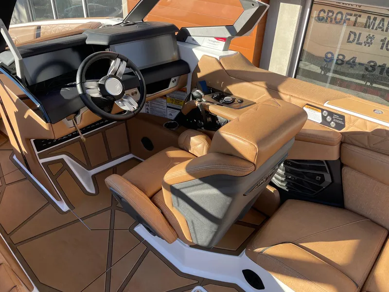 Slide: The Image of 2024 Nautique Super Air Nautique G25 Paragon interior with tan leather seats and modern dashboard. - 6