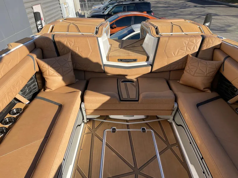 Slide: The Image of Luxurious interior of 2024 Nautique Super Air Nautique G25 Paragon boat with tan upholstery. - 8