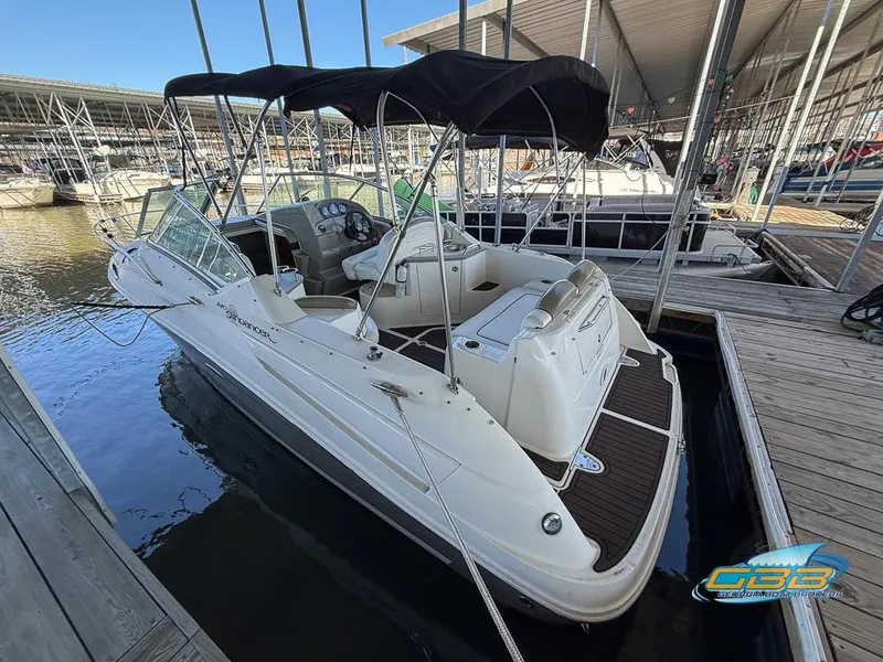 Slide: The Image of 2007 Sea Ray 240 Sundancer boat docked in marina with canopy. - 12