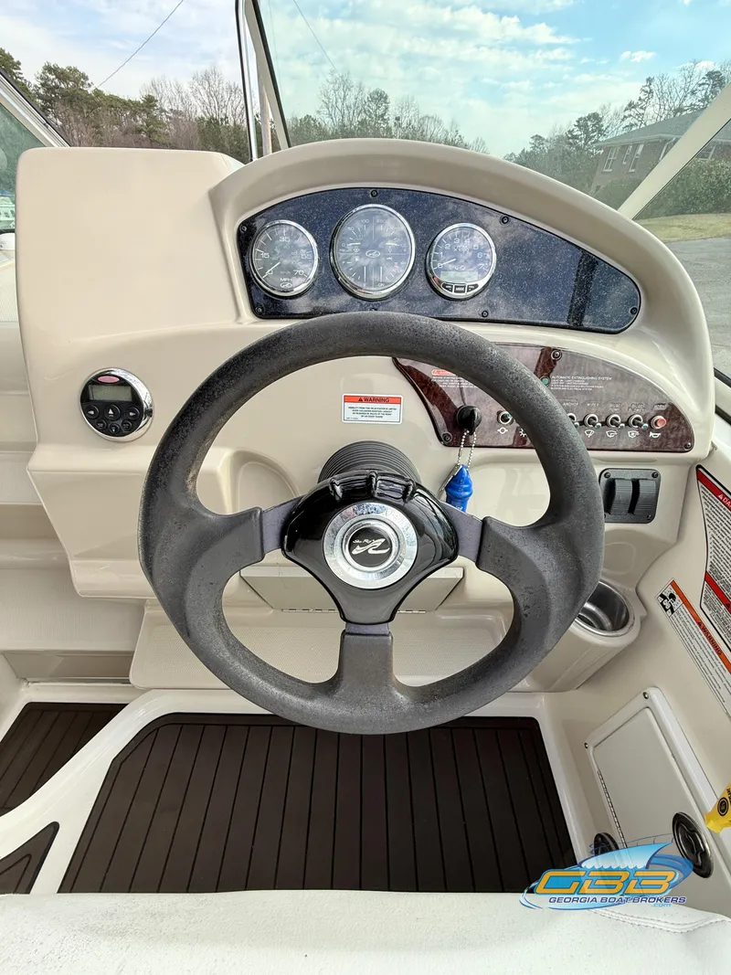 Slide: The Image of 2007 Sea Ray 240 Sundancer dashboard with steering wheel and instrument panel. - 15