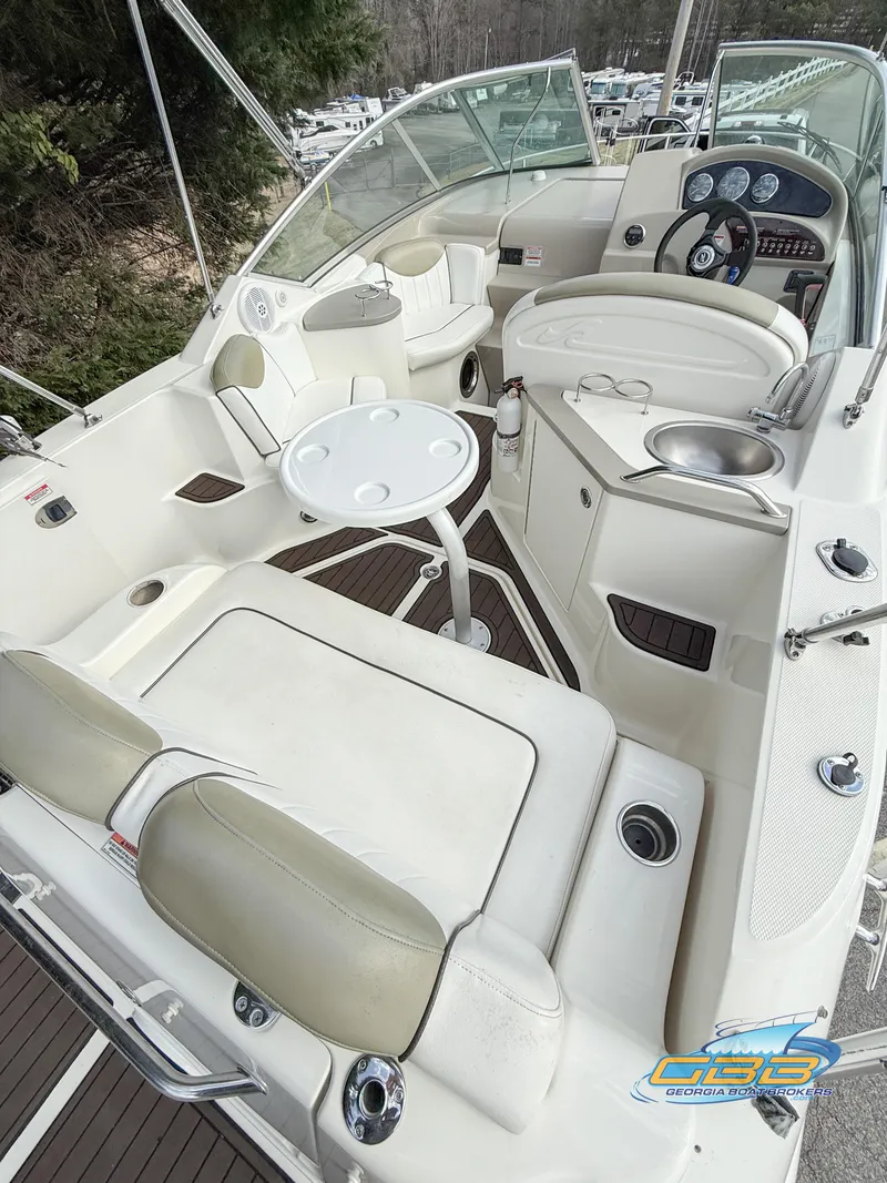 Slide: The Image of 2007 Sea Ray 240 Sundancer boat interior with seating and helm. - 16