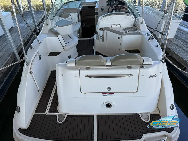 Slide: The Image of 2007 Sea Ray 240 Sundancer boat interior with seating and dashboard, docked at marina. - 17