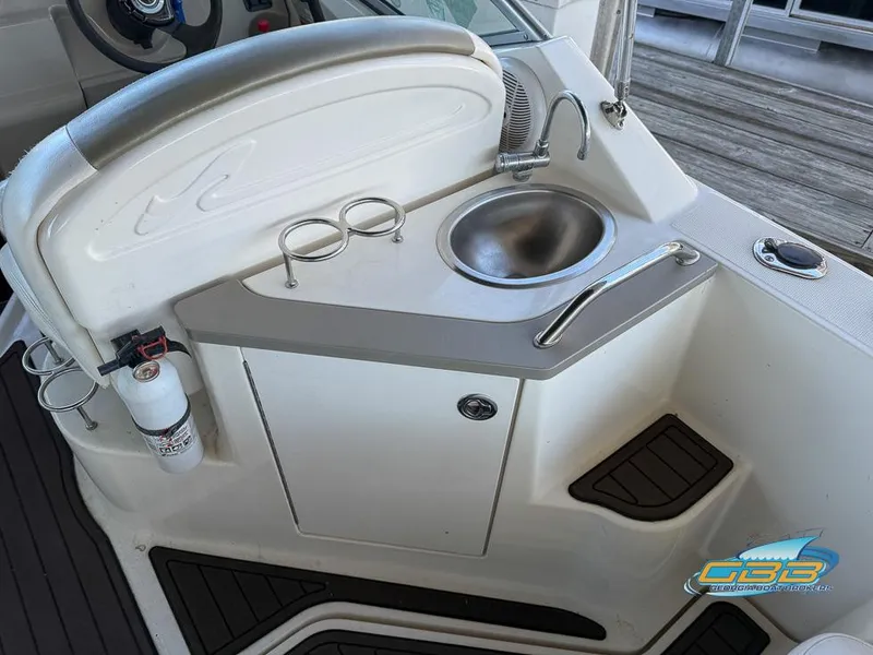 Slide: The Image of 2007 Sea Ray 240 Sundancer boat kitchenette with sink and storage. - 19