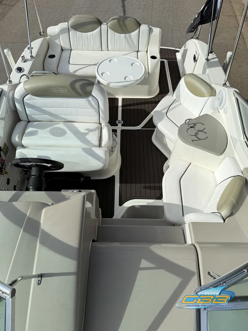 Slide: The Image of 2007 Sea Ray 240 Sundancer boat interior with white seating and table. - 23