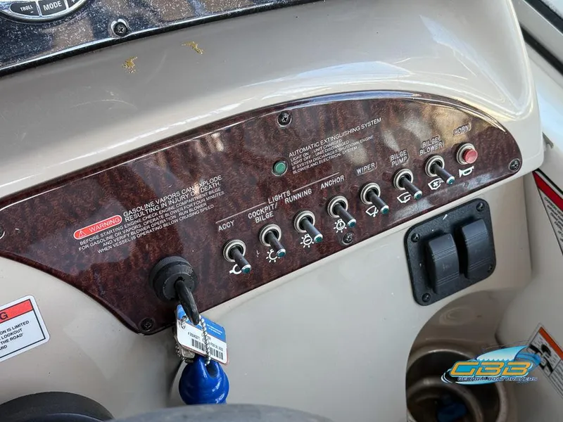 Slide: The Image of Control panel of 2007 Sea Ray 240 Sundancer boat with switches and ignition key. - 24