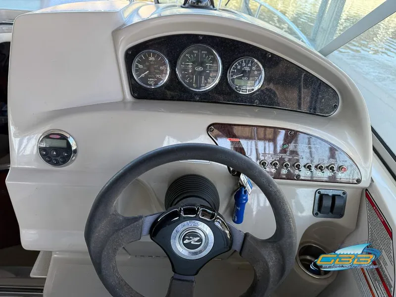 Slide: The Image of 2007 Sea Ray 240 Sundancer dashboard with steering wheel and instrument panel. - 25