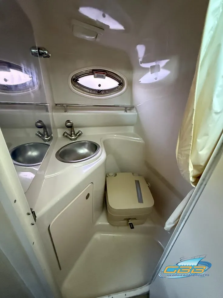 Slide: The Image of Compact bathroom in 2007 Sea Ray 240 Sundancer boat with sink and toilet. - 30
