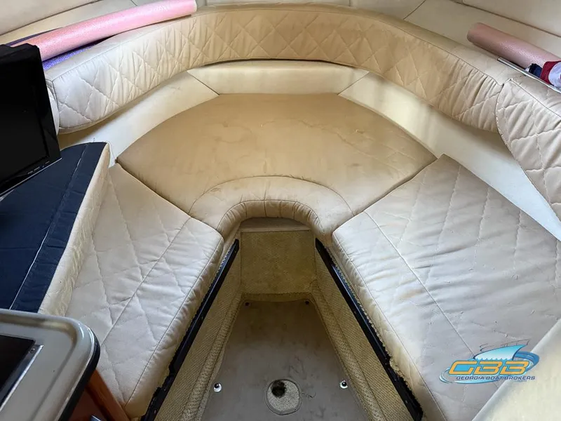 Slide: The Image of 2007 Sea Ray 240 Sundancer cabin interior with beige seating and compact layout. - 31