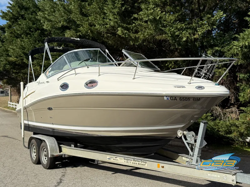 Slide: The Image of 2007 Sea Ray 240 Sundancer boat on trailer, parked near trees. - 7