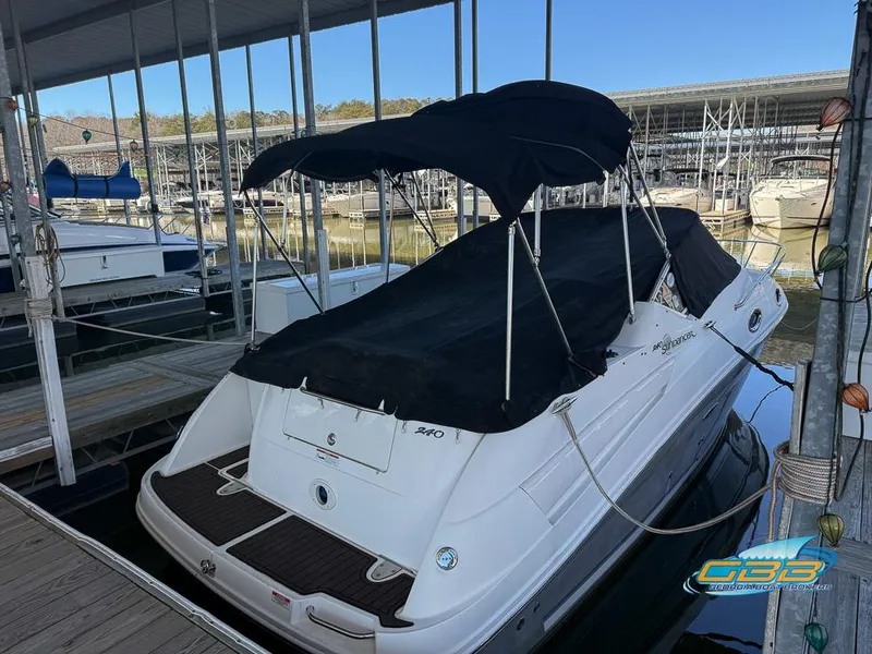Slide: The Image of 2007 Sea Ray 240 Sundancer docked with black canopy and cover. - 9